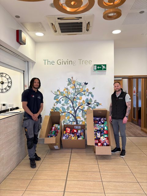 Two Jackson team members with boxes of donated Easter eggs