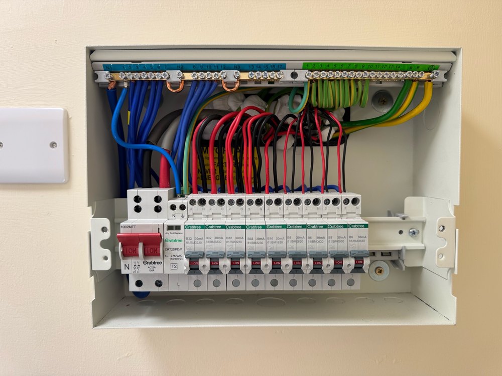 Open domestic consumer unit photographed during Jackson housing electrical work