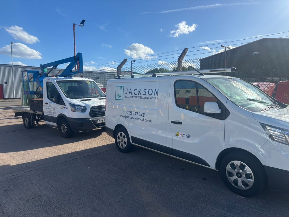 Jackson-branded electrical service van beside a Jackson boom-access vehicle