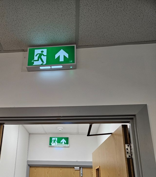 Illuminated emergency exit signs in associated rooms at Shilling Group